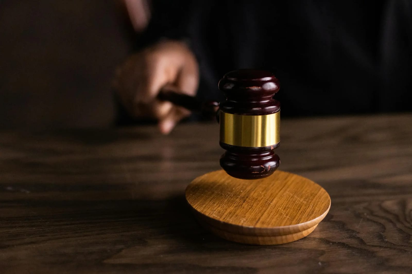 A judge's gavel resting on a wooden block